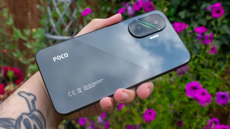 Xiaomi Poco F7 in hand, angled rear view
