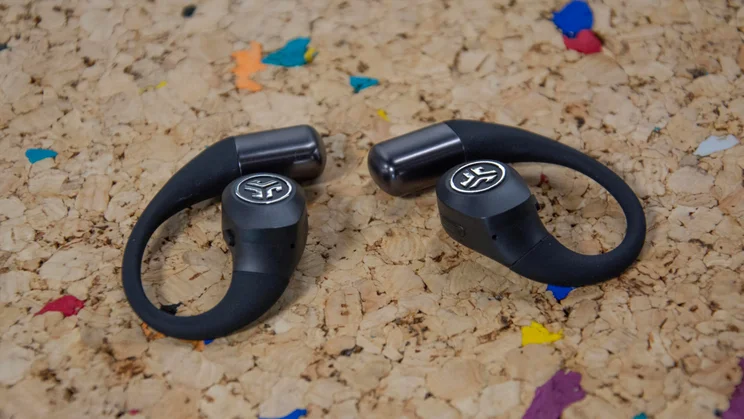 The JLab Epic Open Sport open-ear headphones side-by-side on a cork table