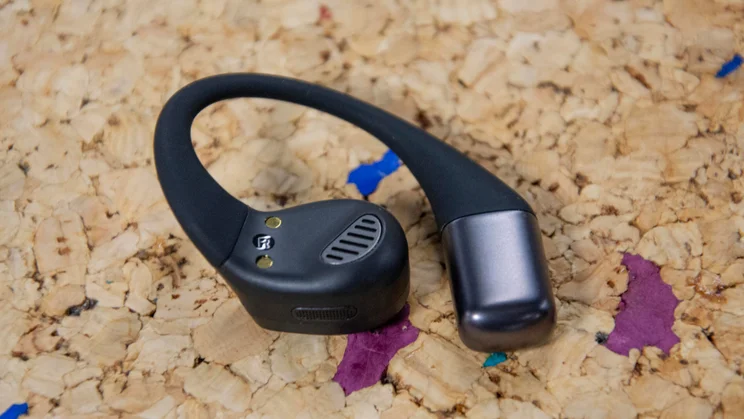 The right earpiece of the JLab Epic Open Sport open-ear headphones turned upside down to show its microphone and speaker driver
