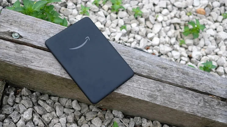 The rear of the Amazon Kindle Colorsoft, pictured on a wooden railway sleeper