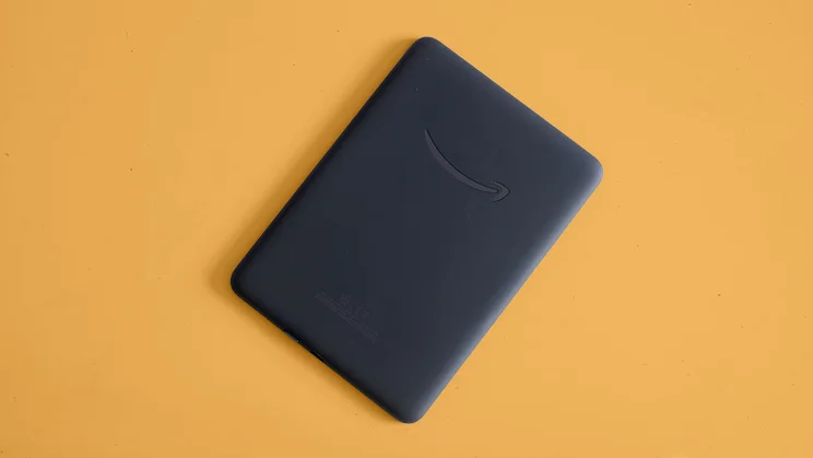 The rear of the The Amazon Kindle Colorsoft, pictured against an orange background