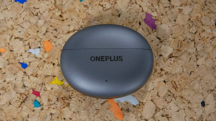 The OnePlus Buds 4's charging case on a cork table with the lid closed
