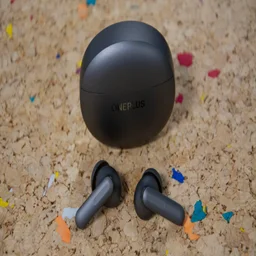 The OnePlus Buds 4 and their charging case on a cork table