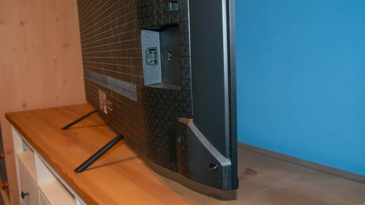 Side view of the Panasonic W95B Mini LED TV's feet protruding out of the rear of the television