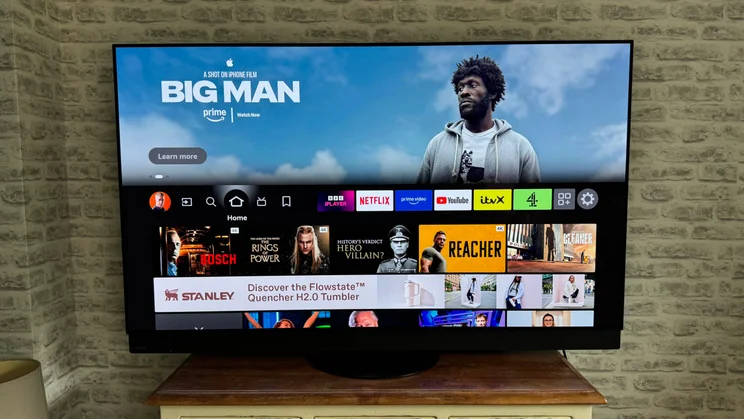 Front view of the Panasonic Z95B OLED displaying the Fire TV OS homepage