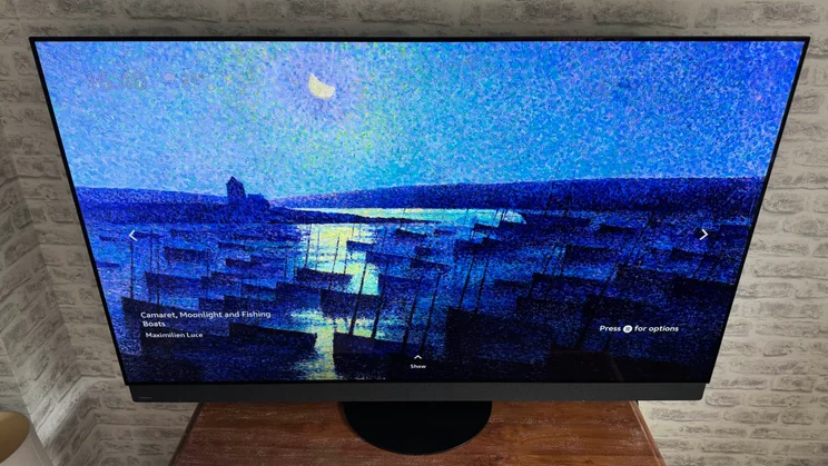 Top-down view of the Panasonic Z95B OLED displaying the Fire TV Ambient Experience screensaver "Camaret, Moonlight and Fishing Boats" by Maximilien Luce
