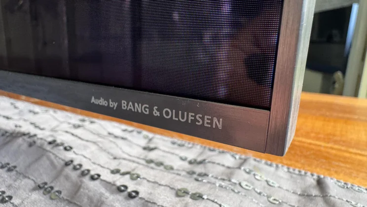 Close-up of the bottom-right corner of the TCL C8K QD-Mini LED TV showing the Audio by Bang & Olufsen logo