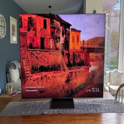 Front view of the TCL C8K QD-Mini LED TV on a kitchen table