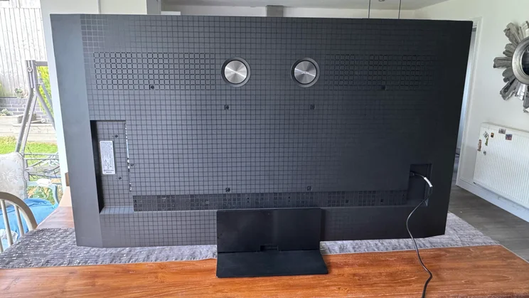 Rear view of the TCL C8K QD-Mini LED TV on a kitchen table