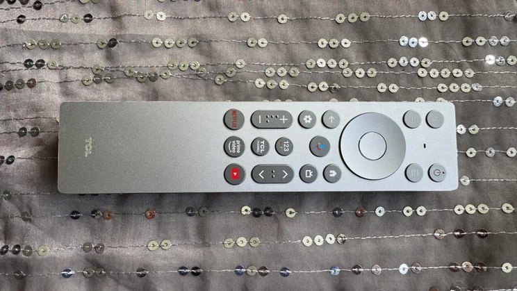 The silver remote control included with the TCL C8K QD-Mini LED TV