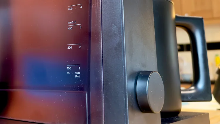 A close up of the Fellow Aiden coffee machine's control dial and water tank