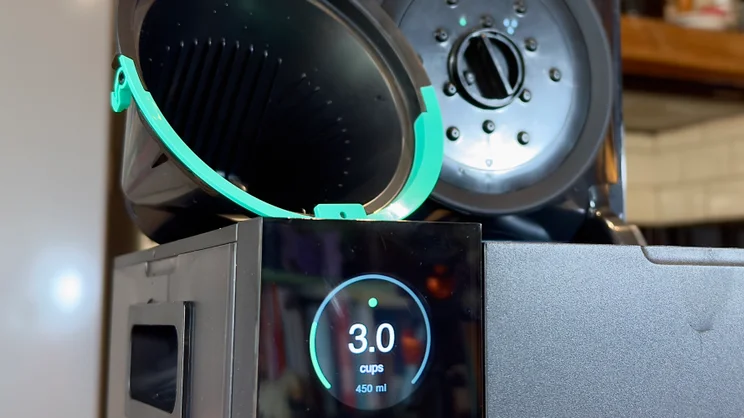 A close up of the Fellow Aiden coffee machine's screen and single cup coffee basket