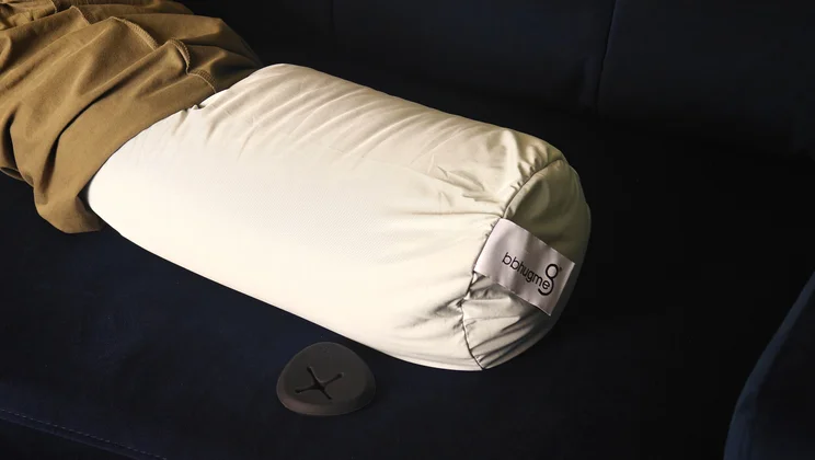 A closeup of the Bbhugme pregnancy pillow with its cover partially removed
