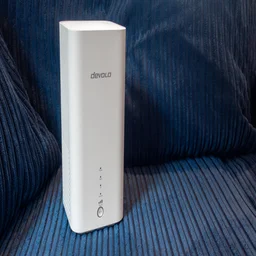 The Devolo 3600 5G shown from the front on a blue fabric background