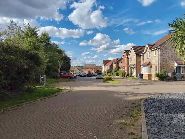 A quiet close of houses with cars parked out front