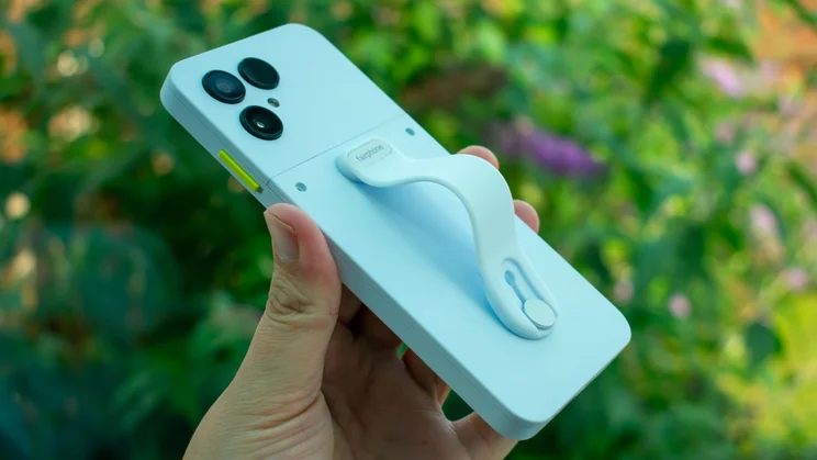 Fairphone 6 in hand with finger loop attachment, angled view