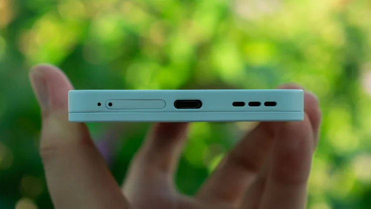Fairphone 6 in hand, showing the bottom edge and charging port