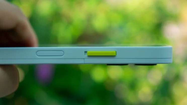 Fairphone 6 in hand, showing the power button and alert slider