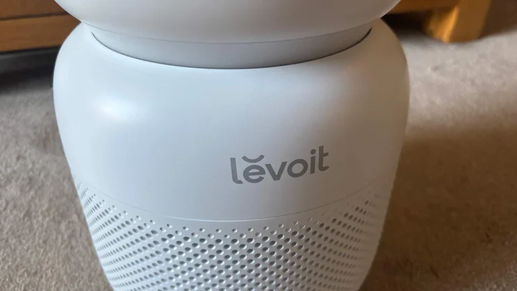 A closeup of the Levoit Sprout air purifier, showing the Levoit logo