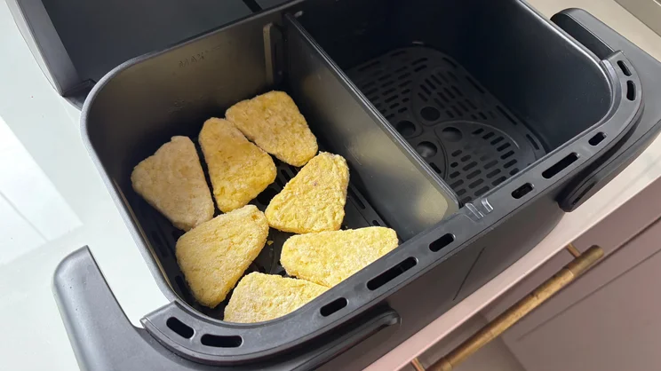 Frozen hash browns inside the drawer of the Philips 1000 Series air fryer