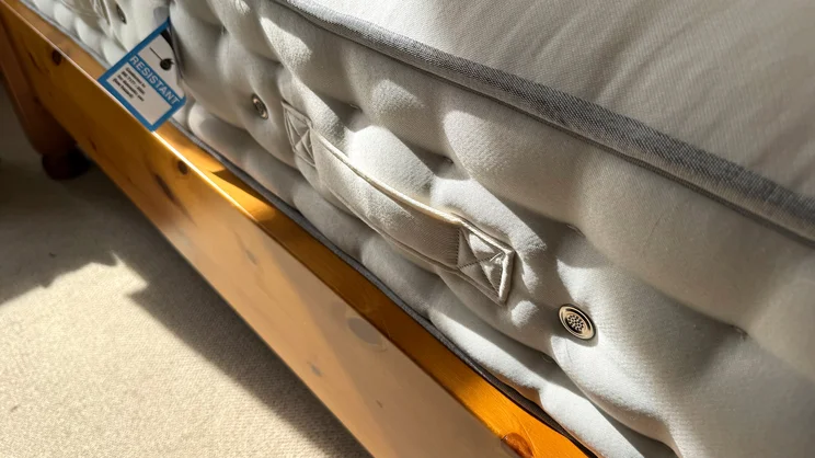 A close up of one of the REM-Fit Natural Lux Hybrid mattress' side handles