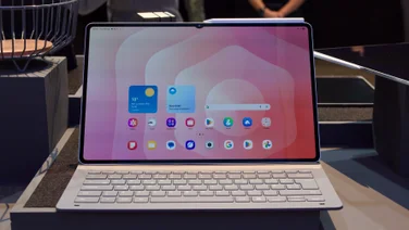 The Samsung Galaxy Tab S11 Ultra pictured on some staging in its keyboard case