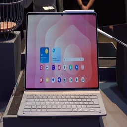 The Samsung Galaxy Tab S11 Ultra pictured on some staging in its keyboard case