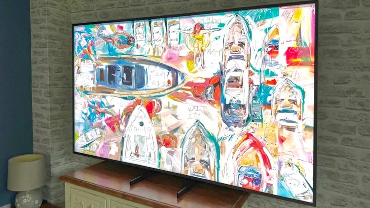 The Samsung 75QN900F shong some artwork, pictured from an angle off to the right