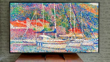 The Samsung 75QN900F pictured from in front, showing a painting onscreen