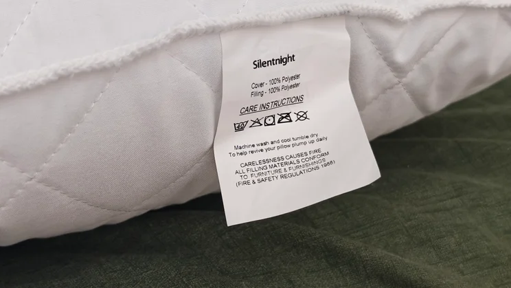A close up of the Silentnight Body Support pillow's care label