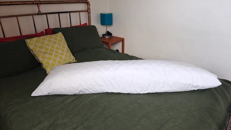 The Silentnight Body Support Pillow on a bed