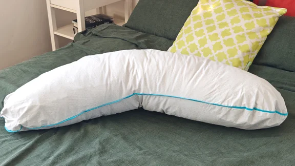 The Simba Body pillow on a bed