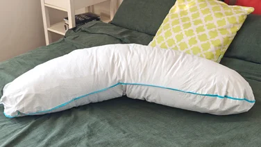The Simba Body pillow on a bed