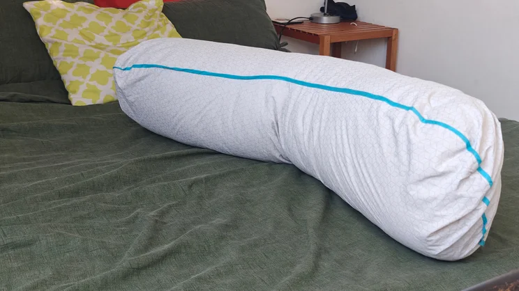 The Simba Body pillow on a bed