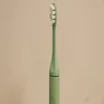 A closeup of the top half of the Suri 2.0 electric toothbrush