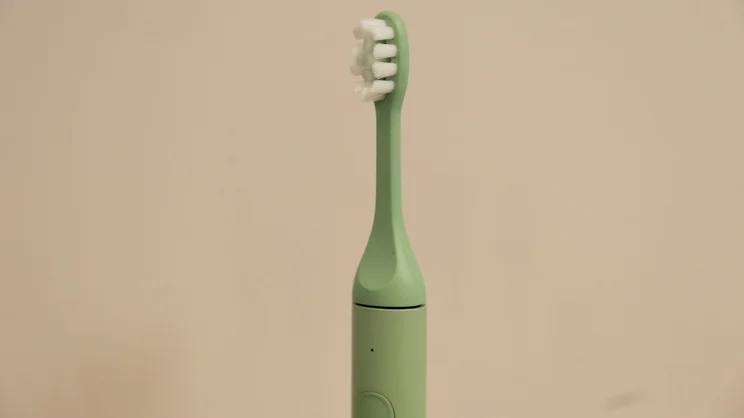 A closeup of the top half of the Suri 2.0 electric toothbrush