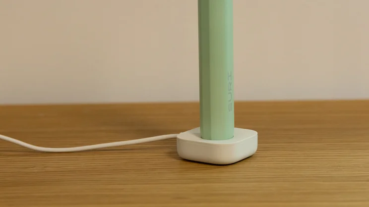 A closeup of the base of the Suri 2.0 electric toothbrush, on its charging stand