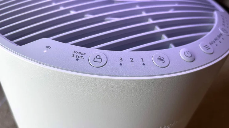 A closeup of the SwitchBot air purifier's control buttons, with blue light on
