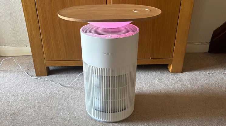 The SwitchBot air purifier with pink light on