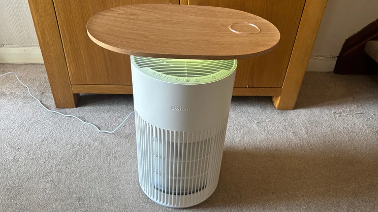The SwitchBot air purifier with yellow light on