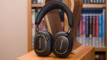 The Bowers & Wilkins Px8 headphones leaning against a headphone stand