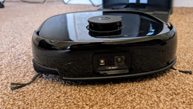 The Eufy 25 cleaning a brown carpet
