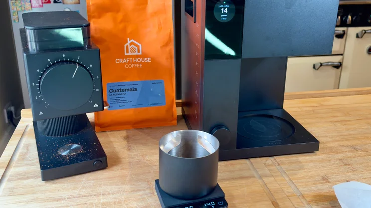 The Fellow Aiden coffee machine with grinder and coffee mug