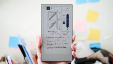 The Remarkable Paper Pro Move shown in hand ad a note onscreen