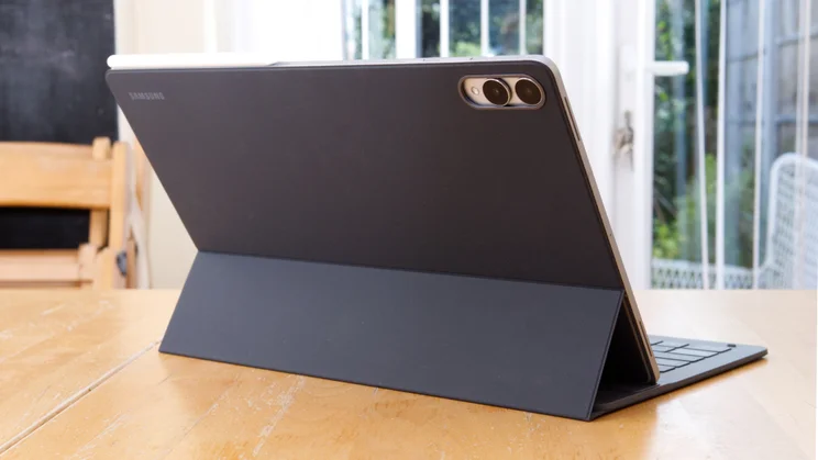 The Samsung Galaxy Tab S11 Ultra pictured from the rear, on a kitchen table in its keyboard case