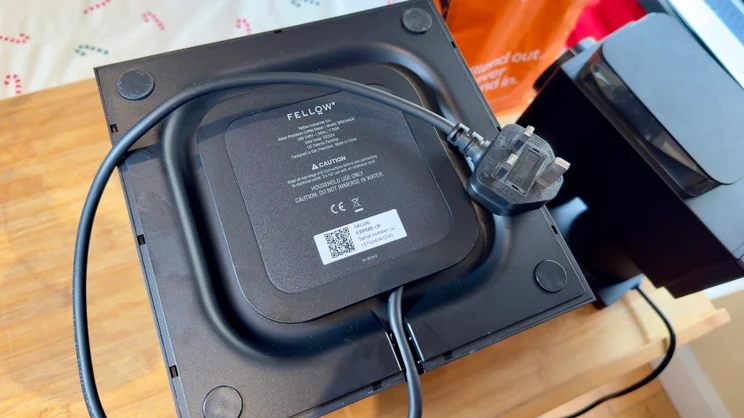 The underside of the Fellow Aiden coffee machine showing the power cable stowage