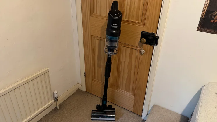 The VAX HomePro Detect Pet-Design vacuum cleaner upright against a door
