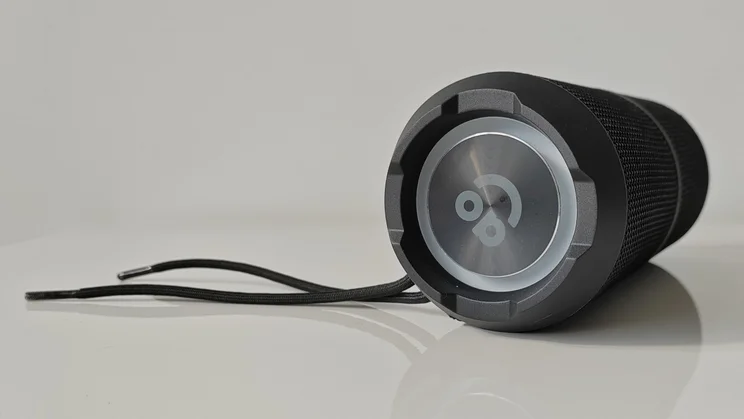 Side view of the AO Portable Wireless Speaker with its shoelace tether attached
