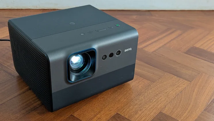 The BenQ GP520 4K projector on a wooden floor