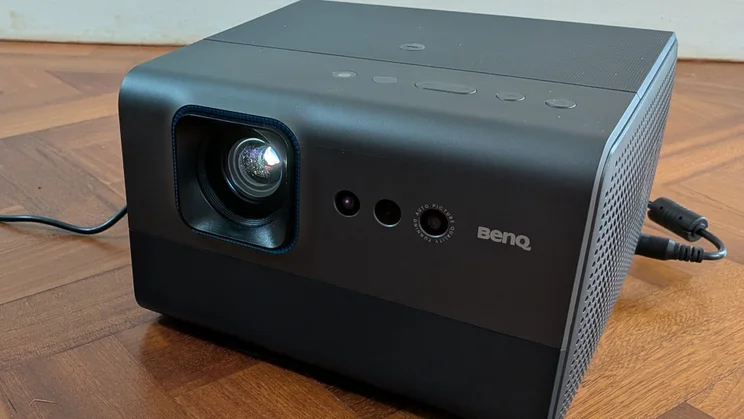 View of the BenQ GP520 4K projector on a wooden floor from the right-hand side
